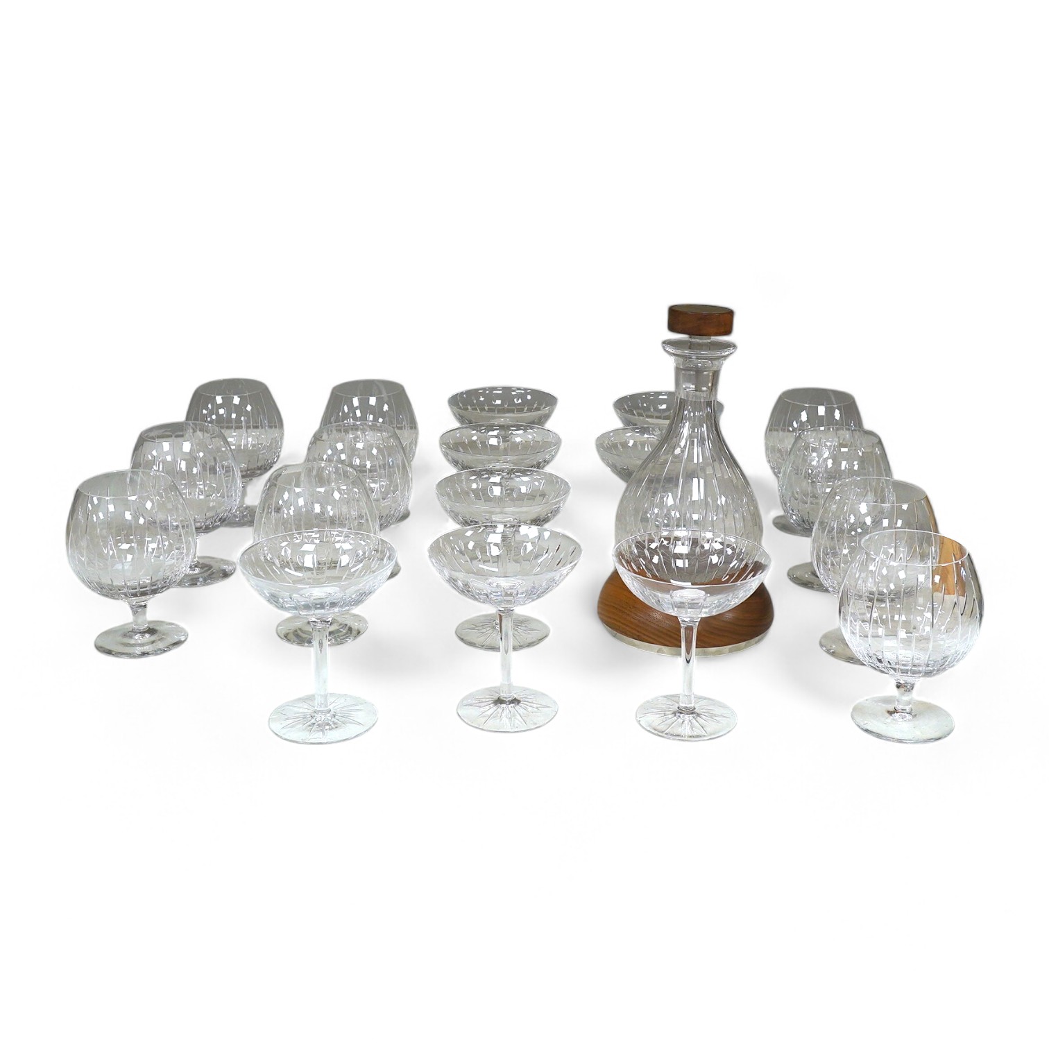 A Linley Glyndebourne pattern cut glass decanter with a silver mounted stopper, on a weighted wooden coaster stand, and a matching set of ten goblets and eight champagne coupes, largest 30cm high. Condition - all in very